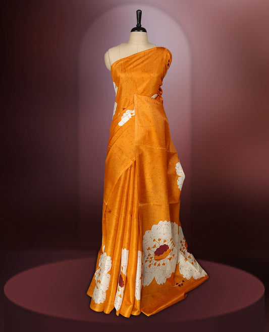 Rust orange colour saree adorned with bold off white floral prints, blending tradition with a modern twist & paired with a matching blouse.