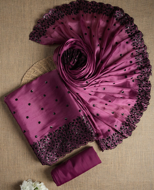 Elegant Mulberry pink colour suit material adorned with black sequin embroidery and floral lace border. Comes with a matching dupatta featuring elegant embroidered motifs and a plain bottom