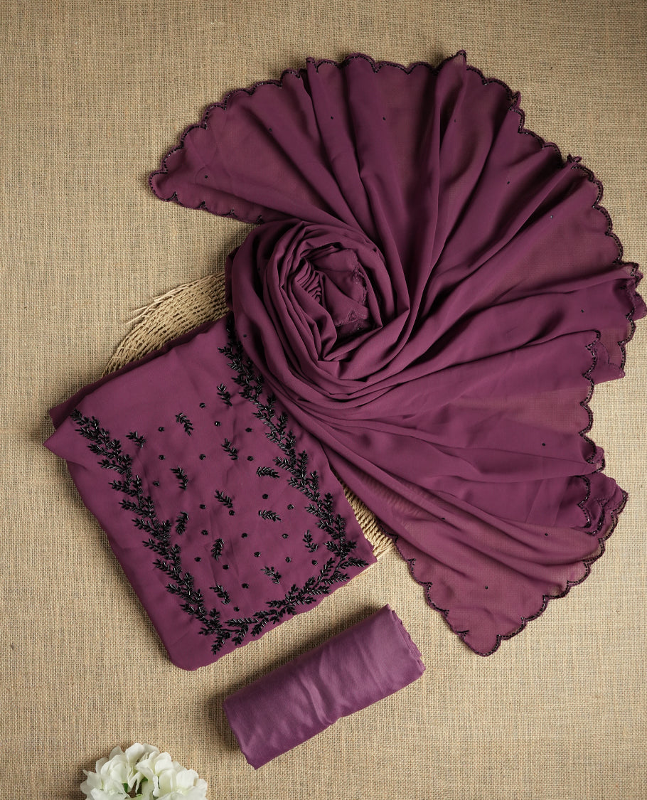 Elegant dark mauve colour suit material adorned with intricate black cut beads work, exuding sophisticated charm & paired with a soft dupatta and a matching plain bottom.