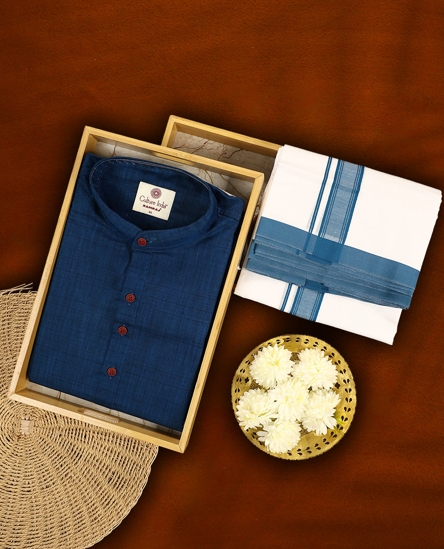 RAMRAJ  Navy blue kurtha paired with a white dhoti, elegantly finished with a matching Navy blue border.
