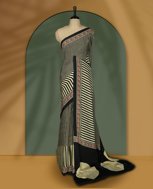 Black and beige colour striped saree with red floral embroidered border and abstract beige pallu detailing & Paired with a matching blouse.