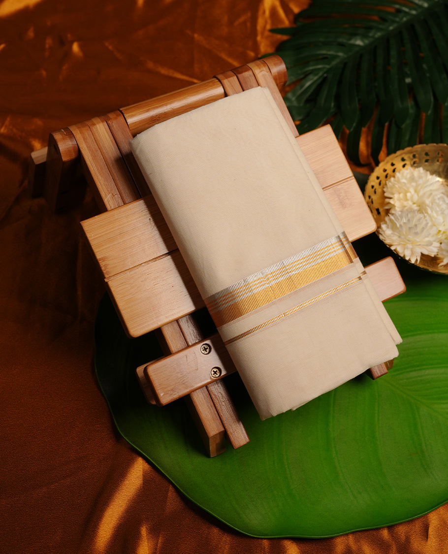 Cream colour cotton double dhoti featuring 2 inch gold and silver kasavu zari border