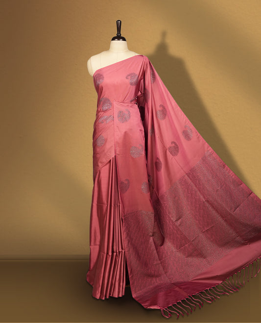 Cherry pink colour semi soft silk saree, adorned with subtle woven mango motifs on the body & The design is elevated with an elegant zari border and pallu, paired with a matching blouse.