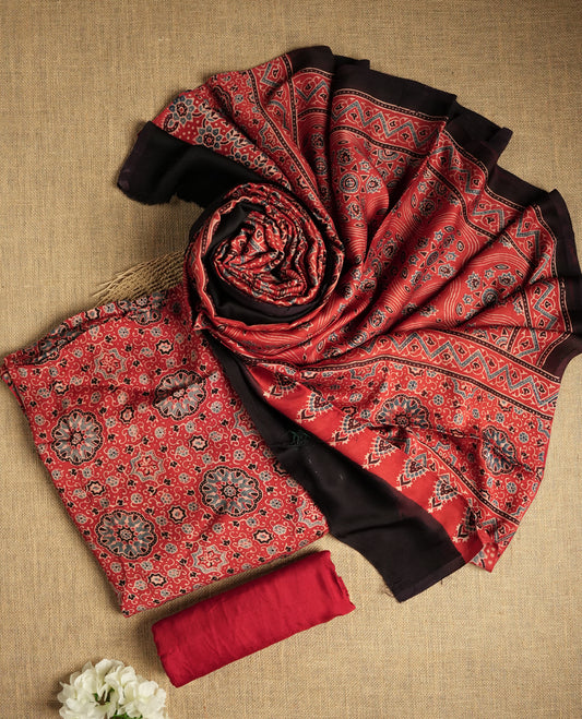 Rich Maroon colour suit material featuring traditional Ajrakh inspired prints in black and beige hues & Paired with a beautifully patterned dupatta and solid matching bottom.