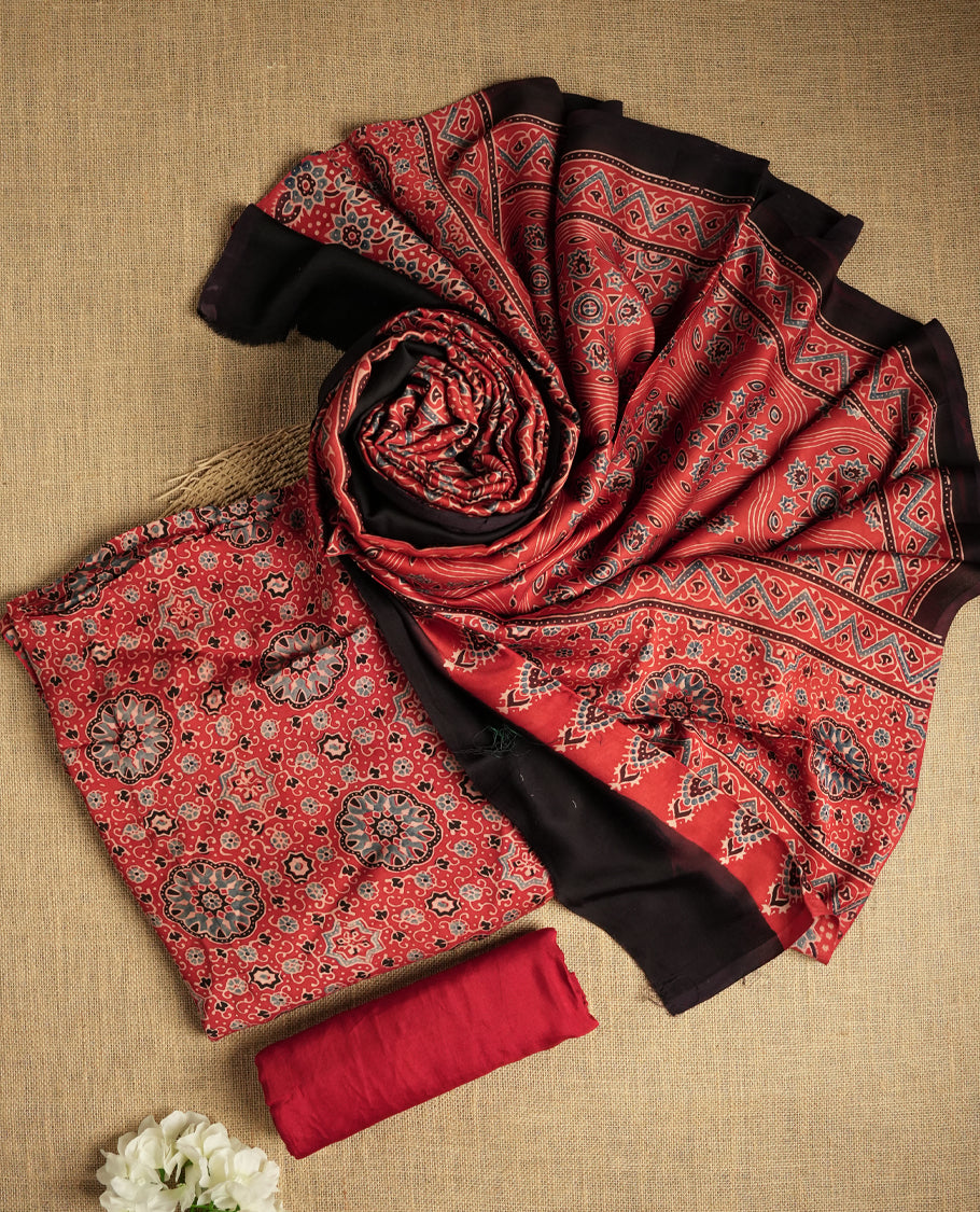Rich Maroon colour suit material featuring traditional Ajrakh inspired prints in black and beige hues & Paired with a beautifully patterned dupatta and solid matching bottom.