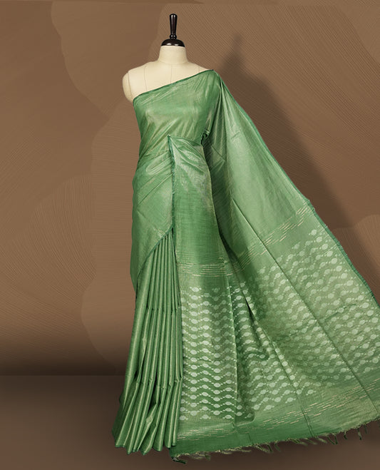 Pastel green colour semi jute tissue saree featuring subtle self weave patterns across the body, complemented by a delicately designed pallu with intricate geometric motifs & Comes with a matching blouse piece for a complete look.