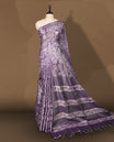Lavender semi jute tissue saree adorned with elegant white floral motifs all over the body, paired with a beautifully woven pallu and patterned borders & Comes with a matching blouse piece.