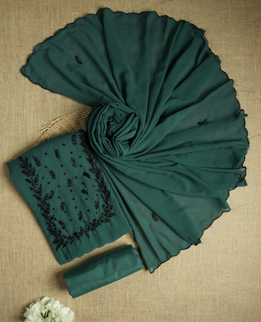 Elegant teal colour suit material adorned with intricate black cut beads work, exuding sophisticated charm & paired with a soft dupatta and a matching plain bottom.