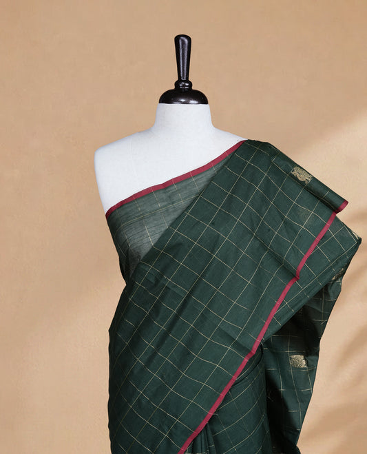 Green colour chettinad cotton saree featuring Gold zari check with Peacock motifs on body, complemented by Red colour piping border, paired with matching blouse.