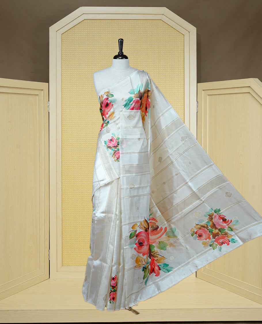 Cream Colour Organza Kerala Saree Featuring Digital Rose Floral Prints Across The Body, Enhanced With Subtle Light Gold Zari Stripes And A Light Gold Zari Border, Finished With Gold Tassels And A Matching Blouse Piece