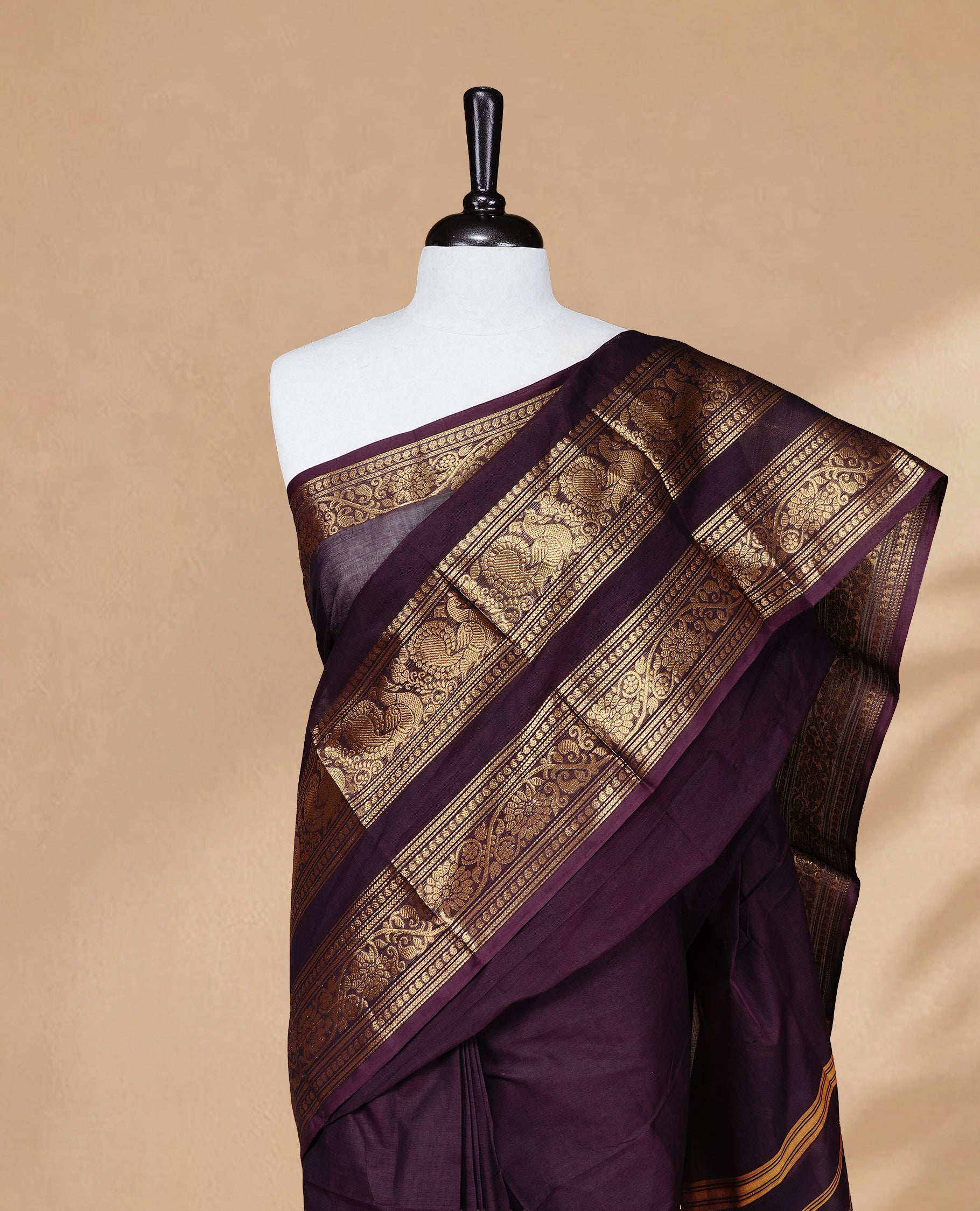 Chocolate brown colour Chettinad cotton saree featuring Elegant plain body, complemented by self colour with Gold zari border, paired with matching blouse piece.