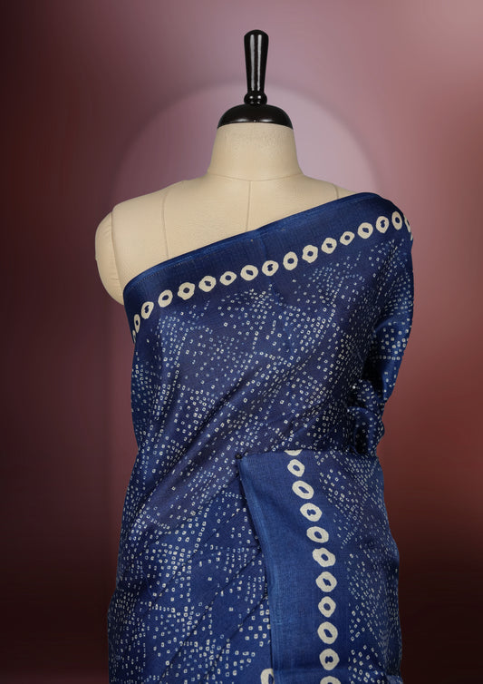 Navy blue colour saree with intricate cream dotted patterns and a striking Madhubani inspired pallu, The soft fabric offers a graceful drape, making it perfect for festive and formal occasions, paired with blouse.