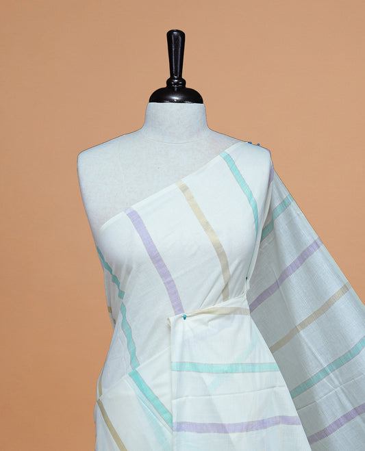 Cream Colour Cotton Kerala Saree Featuring Green & Light Purple Strips On The Body & Pallu, Paired With A Matching Blouse Piece.