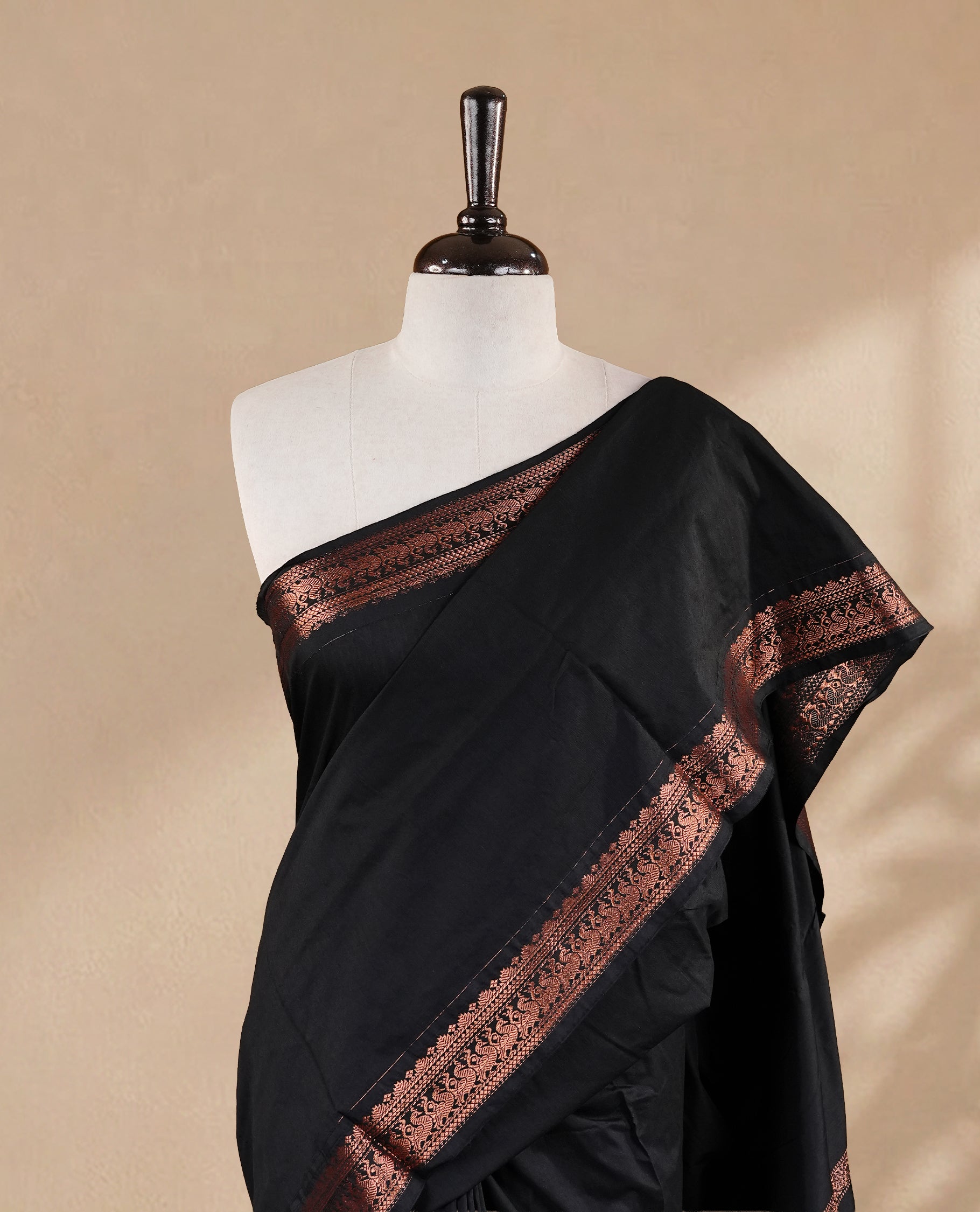 Black colour kalyani cotton saree featuring elegant plain body, complemented by self colour with Antique zari border, paired with matching blouse piece.