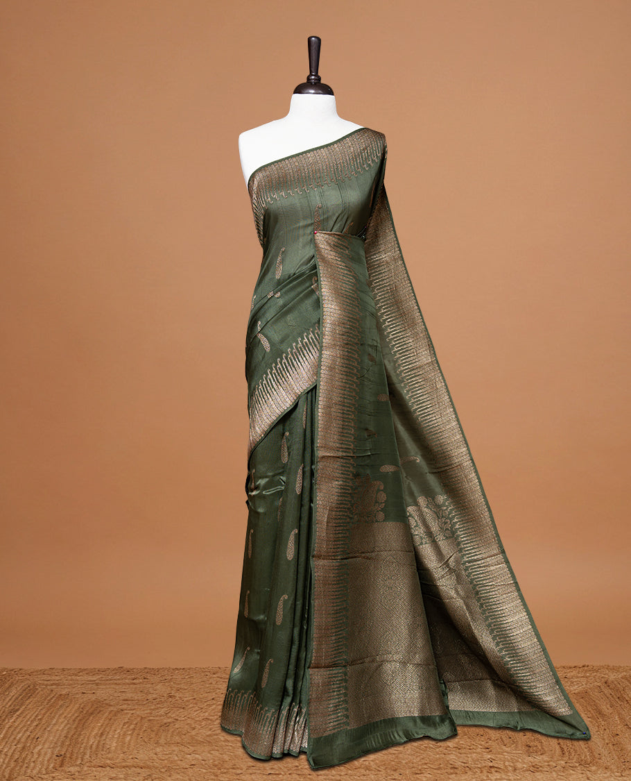 Green colour Semi Banaras Tussar Georgette Featuring Gold zari Leaf pattern on body, Finished with Gold zari border and paired with matching blouse piece.
