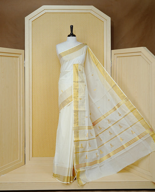 Cream Cotton Colour Kerala Saree Featuring Delicate Gold Mango Motifs, Enhanced with a Rich Gold Zari Border and Fine Striped Detailing. The Elegant Pallu Completes the Traditional Look and Comes with a Matching Blouse Piece.