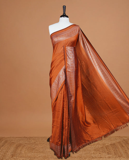 Rust Orange colour semi silk saree featuring Elegant plain body with fancy border, comes with matching self colour blouse piece.