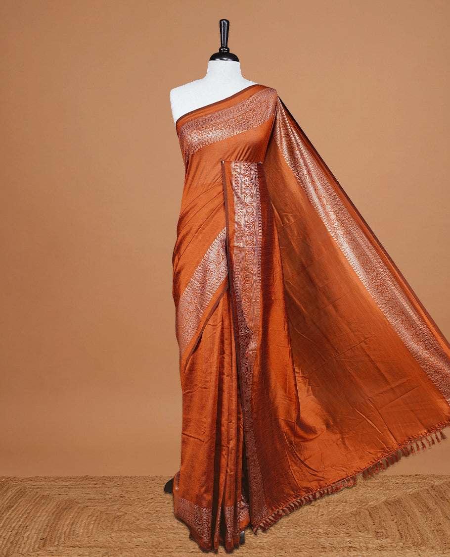 Rust Orange colour semi silk saree featuring Elegant plain body with fancy border, comes with matching self colour blouse piece.