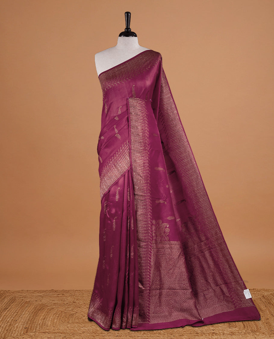 Dark Rouge colour Semi Banaras Tussar Georgette Featuring Gold zari Leaf pattern on body, Finished with Gold zari border and paired with matching blouse piece.