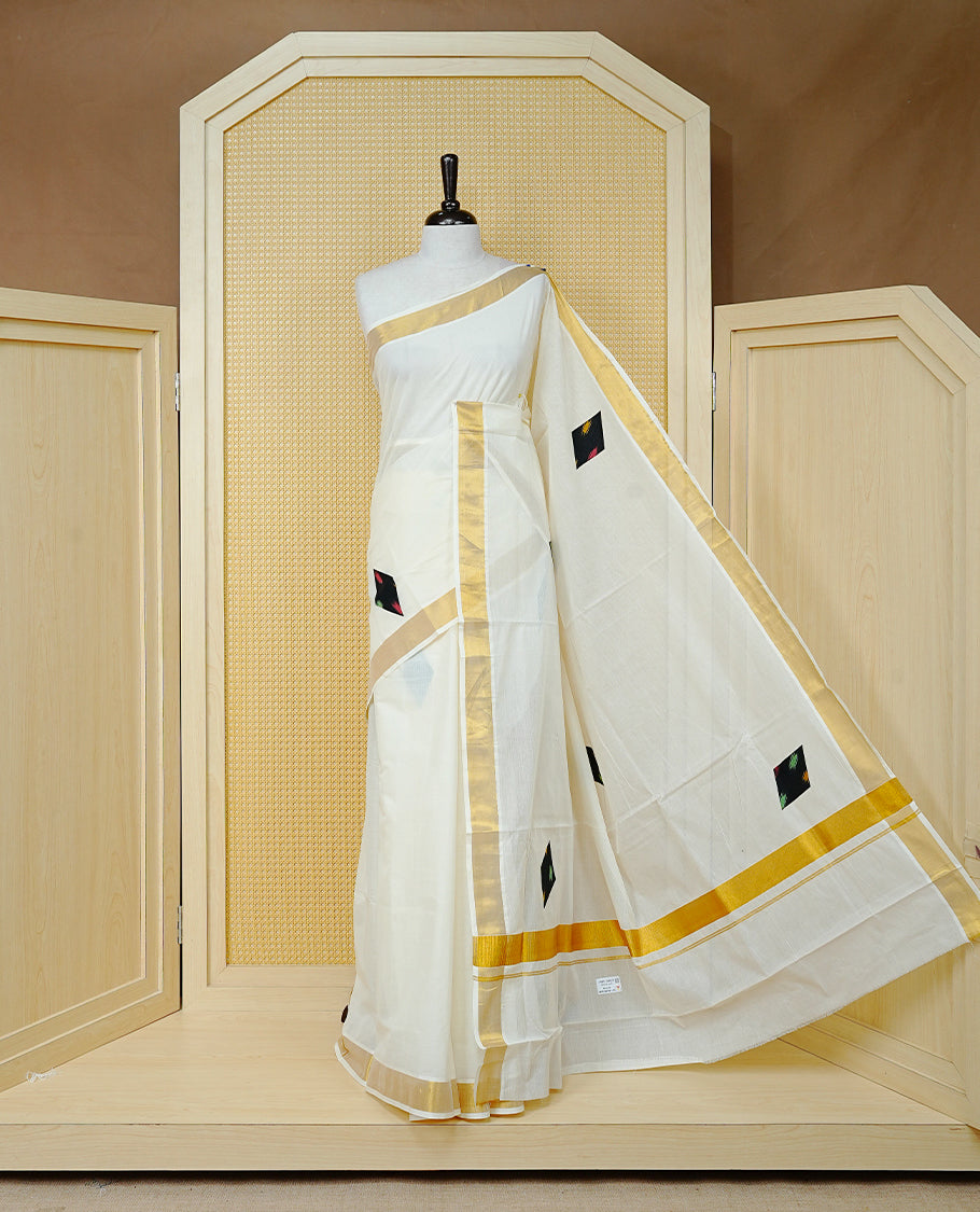 Cream Colour Kerala Saree Featuring Black Colour  Geometric Motifs And A Classic Gold Zari Border, Paired With A Matching Blouse Piece.