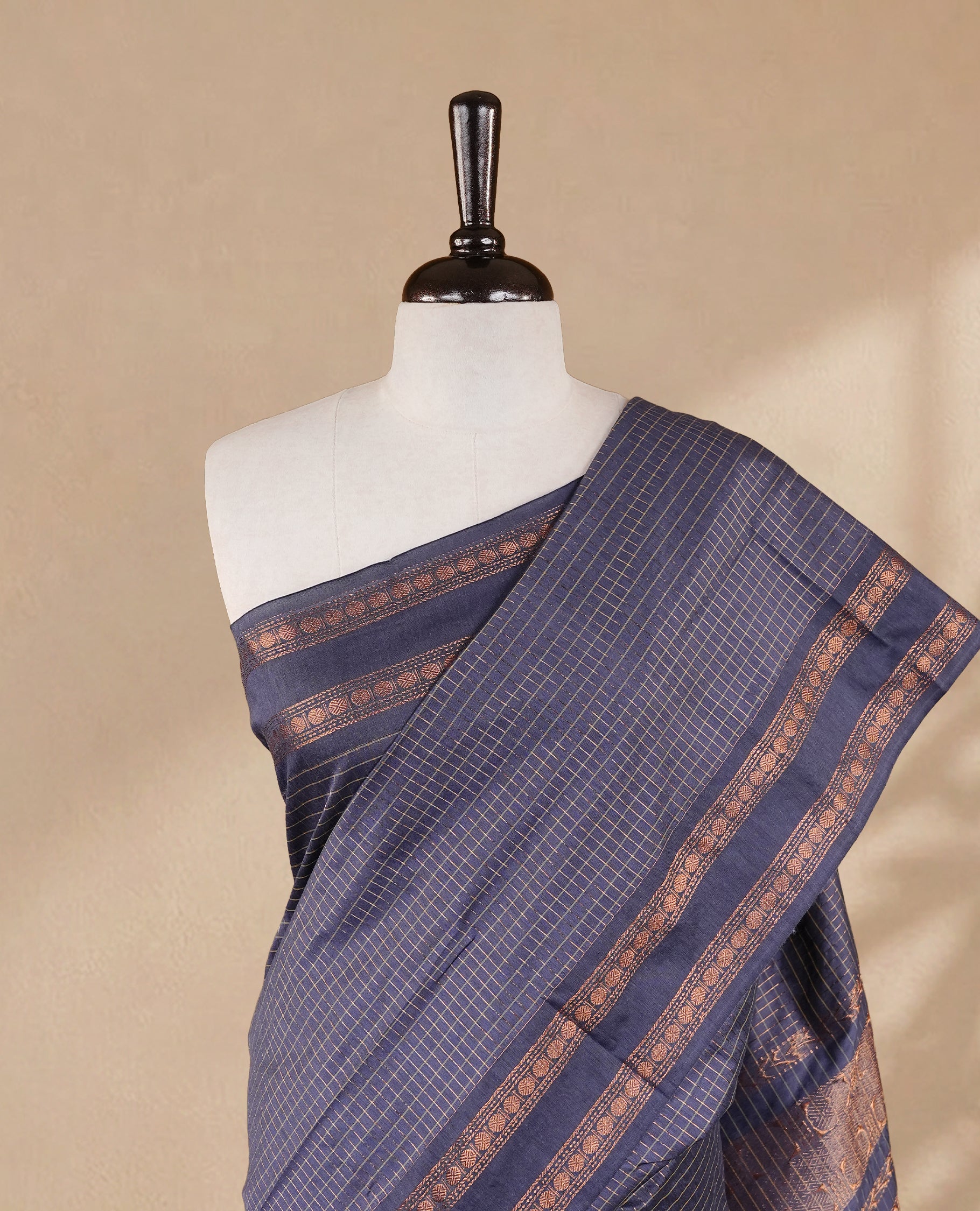 Grey colour kalyani cotton saree featuring gold zari check pattern on body, complemented by self colour with Antique zari border, paired with matching blouse piece.