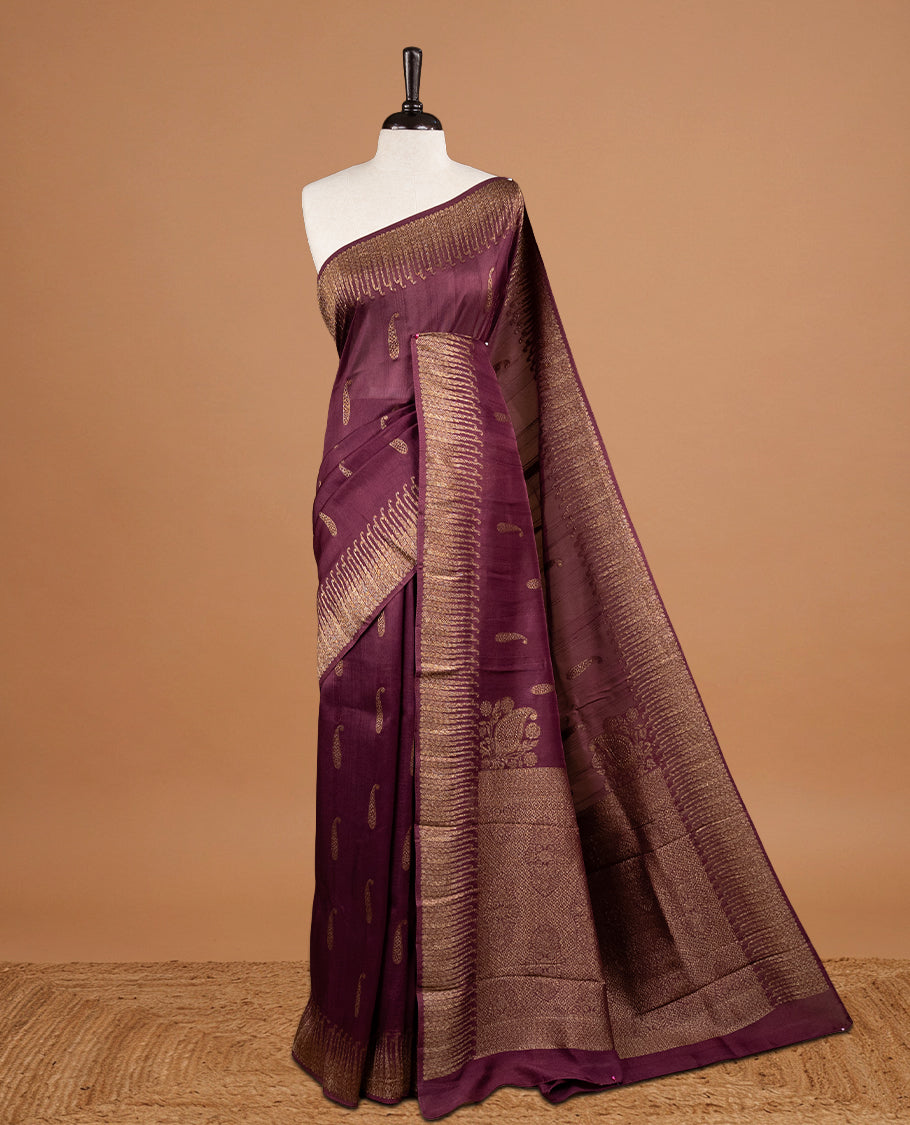 Burgundy colour Semi Banaras Tussar Georgette Featuring Gold zari Leaf pattern on body, Finished with Gold zari border and paired with matching blouse piece.