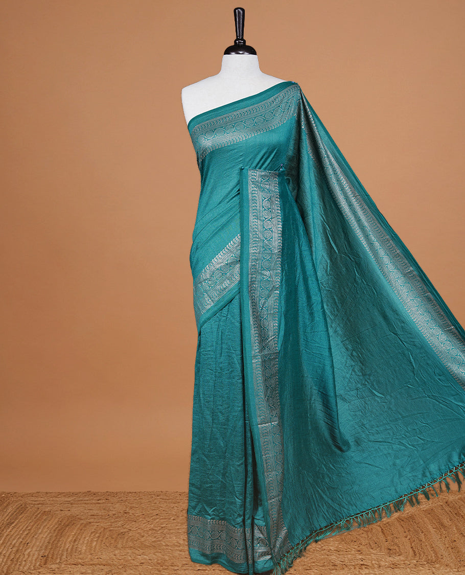 Aqua colour semi silk saree featuring Elegant plain body with fancy border, comes with matching self colour blouse piece.