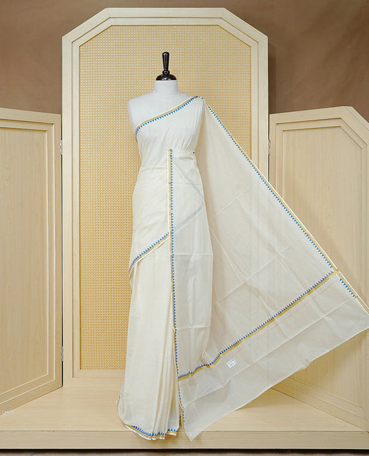 Cream Colour Cotton Kerala Saree Featuring A Gold Zari Border And Blue Temple Edging, Paired With A Matching Blouse Piece