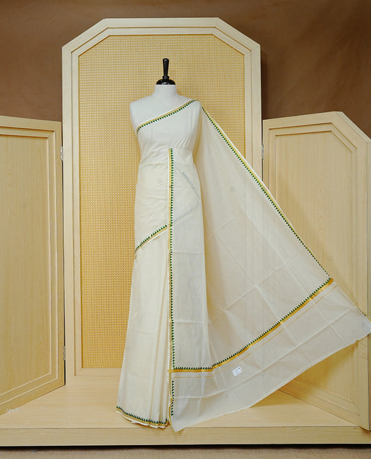 Cream  Colour cotton Kerala saree Featuring  with a gold zari border and green temple edging. Paired with a matching blouse piece.
