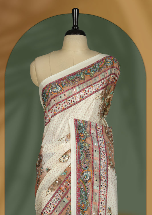 Off white colour saree with subtle polka dots, adorned with ornate multicolored borders and a traditional paisley pallu & Paired with a matching blouse.