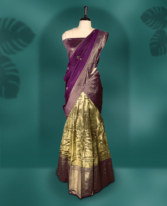 Rich Semi stitched purple and gold dhavani set featuring a zari detailed blouse, flowing dhavani, and golden pleated skirt, A perfect blend of tradition and elegance, ideal for festive occasions and cultural celebrations.