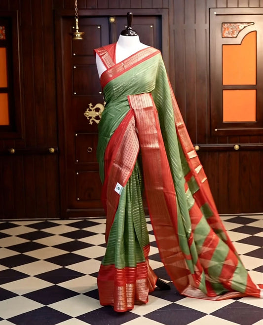 Green colour semi Banarasi saree featuring elegant gold zari stripes on the body, a contrasting red border adorned with intricate gold zari work, and a rich pallu. Paired with a matching blouse