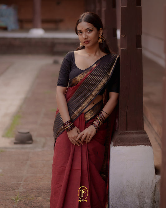 Brick Red colour Chettinad cotton saree with a plain body, featuring a traditional border and pallu in Dark Brown colour, paired with a matching blouse piece