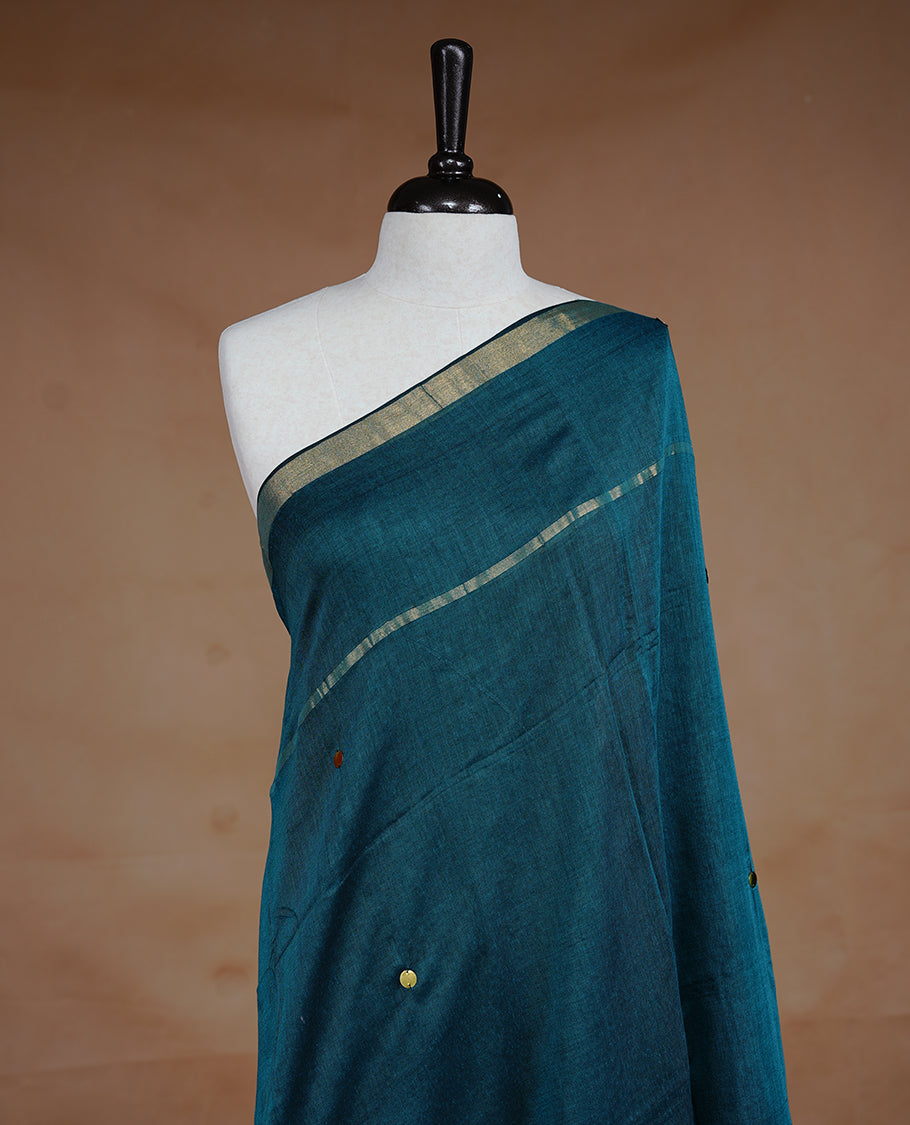 Blue colour Mul Cotton saree featuring a plain body with sequin detailing, highlighted by a small gold colour border, without blouse piece.