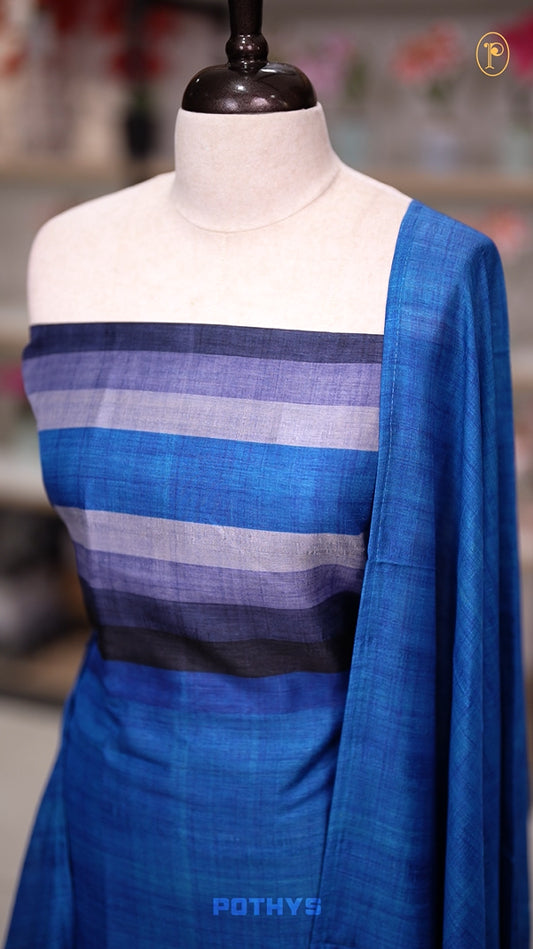 Blue colour semi tussar silk salwar material featuring elegant horizontal stripes on the yoke and dupatta, woven in shades of grey and navy & Paired with a matching plain bottom.