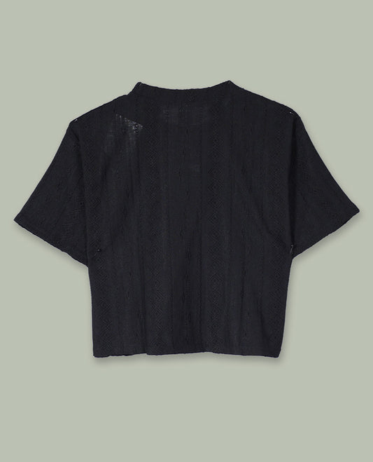 Black short-sleeve crop top with round neckline and subtle all-over self-textured geometric pattern.