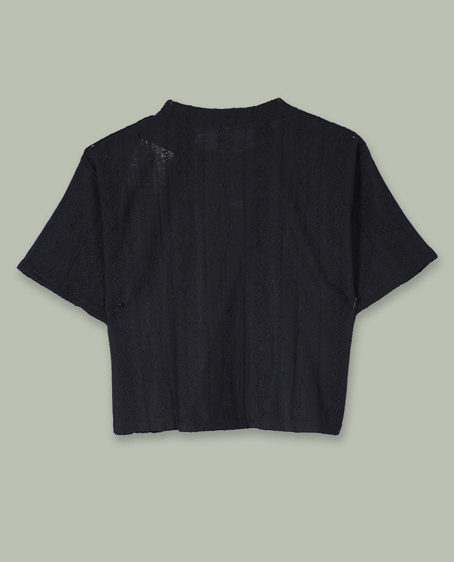 Black short-sleeve crop top with round neckline and subtle all-over self-textured geometric pattern.