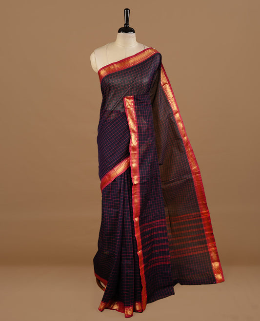 Dark blue colour chettinad cotton saree featuring  Check pattern  on body, complemented by magenta colour with zari border, paired with matching blouse piece.