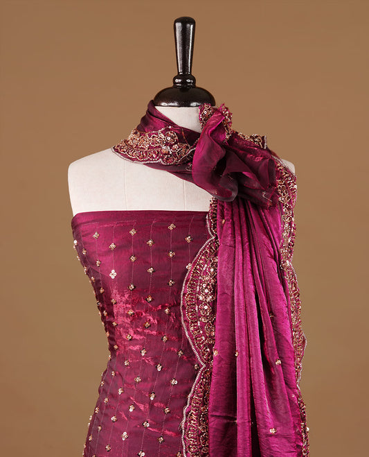 Burgundy colour churidhar material featuring cut beads and sequins work on the body, paired with a matching unstitched bottom and worked dupatta.