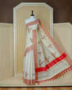Cream Colour Kerala Saree Featuring Plain Body ,Complemented By A Red  Zari With Indian Map Border ,Enhance By A Gold Zari & Red  Pallu ,Paired With A Matching Blouse Piece.