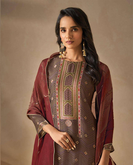 Brownish Gray colour suit material with silk jacquard digital print top with embroidery highlighted sleeve work, paired with matching satin bottom and a contrast lightweight printed dupatta.