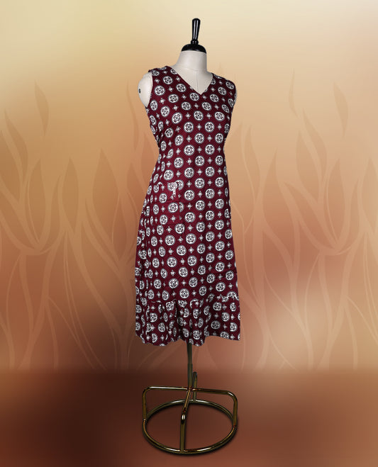Dark maroon colour sleeveless nightwear with intricate beige and black floral prints in circular patterns, Designed with a V neckline, this kurthi comes with matching fabric sleeves included for a versatile look.