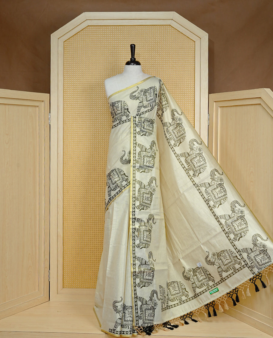 Cream colour Tissue kerala saree featuring Elegant plain body, complemented by Elephant print border, comes with matching blouse piece.