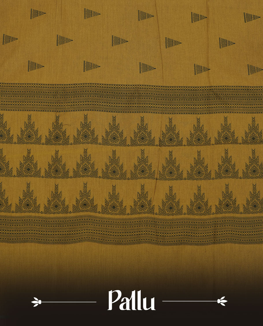 Dark mustard colour poly cotton saree with black temple motifs on the body, paired with a matching pallu with black woven traditional border, and a coordinated all‑over geometric printed blouse piece.