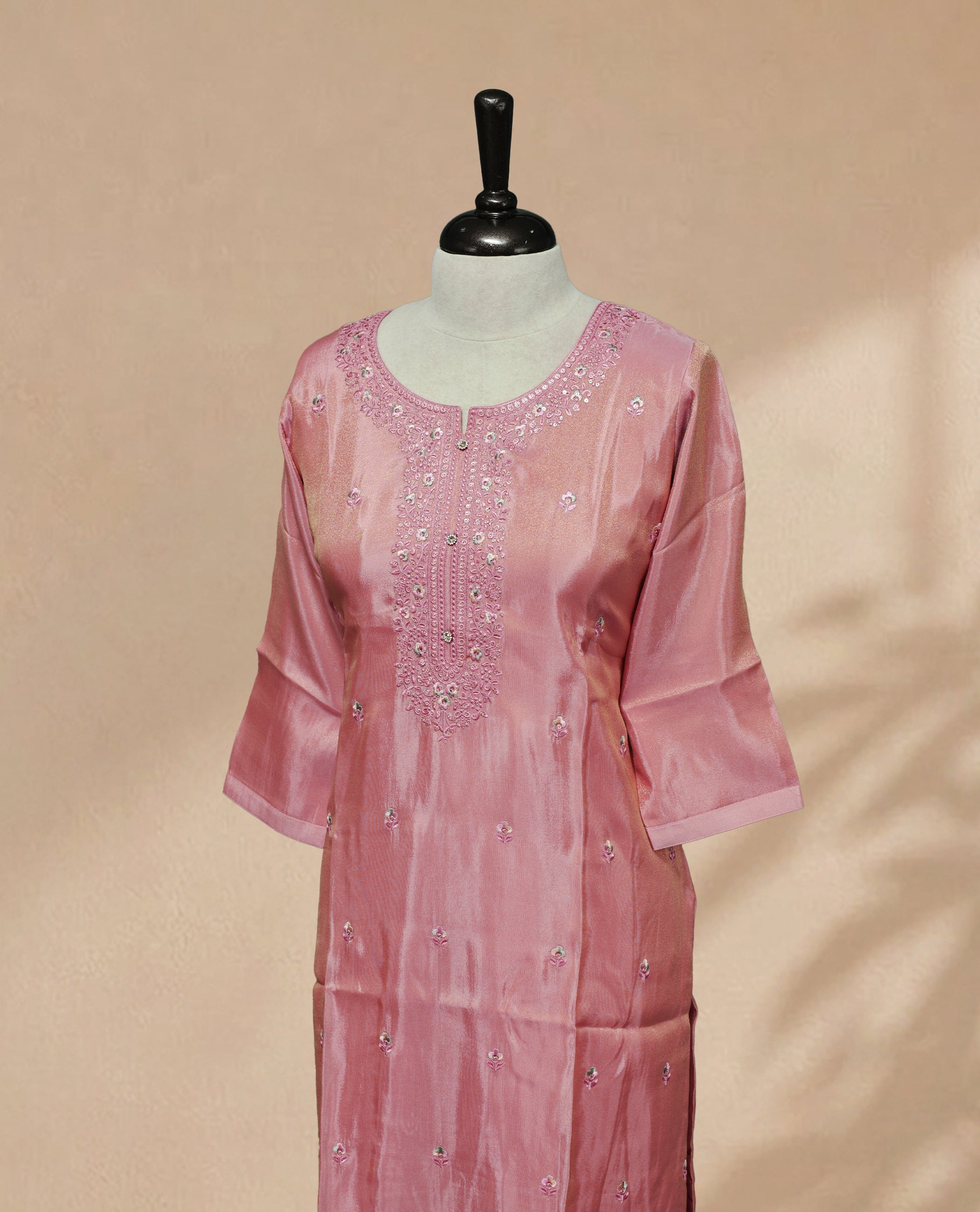 Peach Pink Kurti featuring floral threadwork across the body, a U-shaped neckline adorned with thread work, and a 3/4-sleeve design.