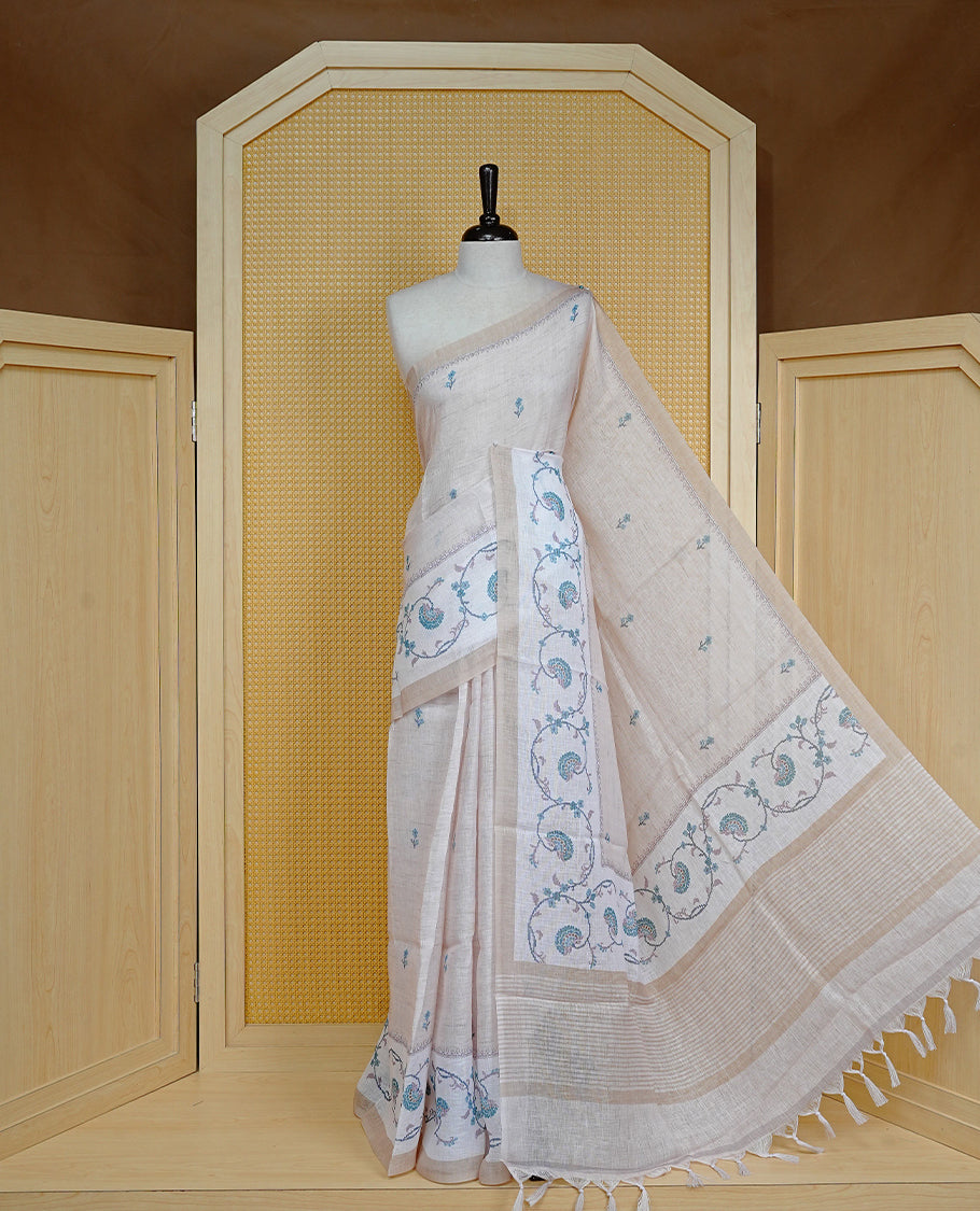 Beige colour semi linen saree featuring floral print on body, complemented by contrast Light gold colour with Design print border, comes with matching blouse piece.