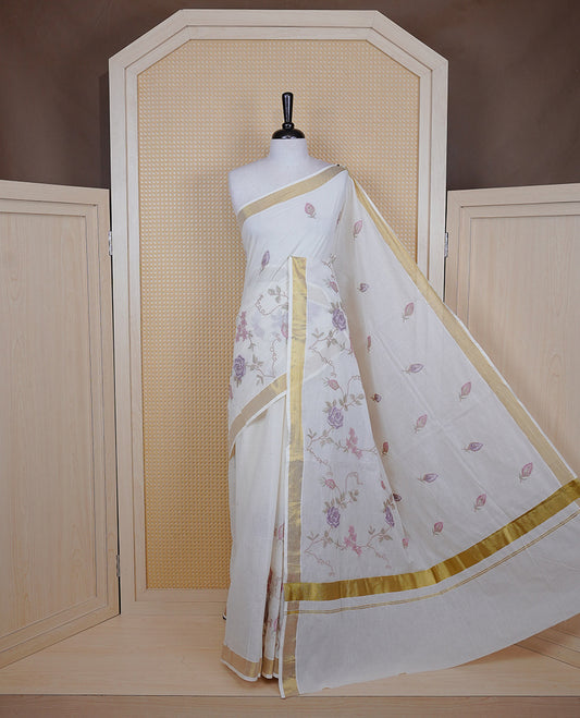 Cream colour Cotton Kerala saree featuring Floral Thread Embroidery work on body, complemented by gold kasavu Border, comes with matching blouse piece.
