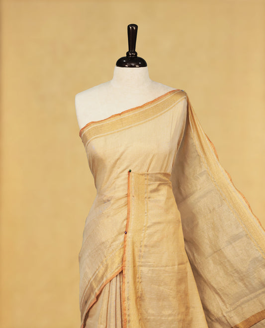 Light Gold colour Semi Tissue Silk saree featuring Elegant plain body, Enhanced with Gold tissue Border & Striped Pallu & beautiful Tassels for Elegant Prefect Look.