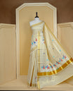 Cream colour Tissue kerala saree featuring Embroidery buttas on body, complemented by Leaf thread work & kasavu kara, comes with matching blouse piece.