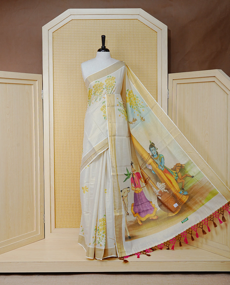 Cream Colour Tissue Kerala Saree Featuring Vibrant Digital Krishna & Radha Onam Theme  Printed Pallu, Beautifully Enhanced With A Classic Gold Zari Border And Contrast Tassels. Paired With A Matching Blouse Piece.